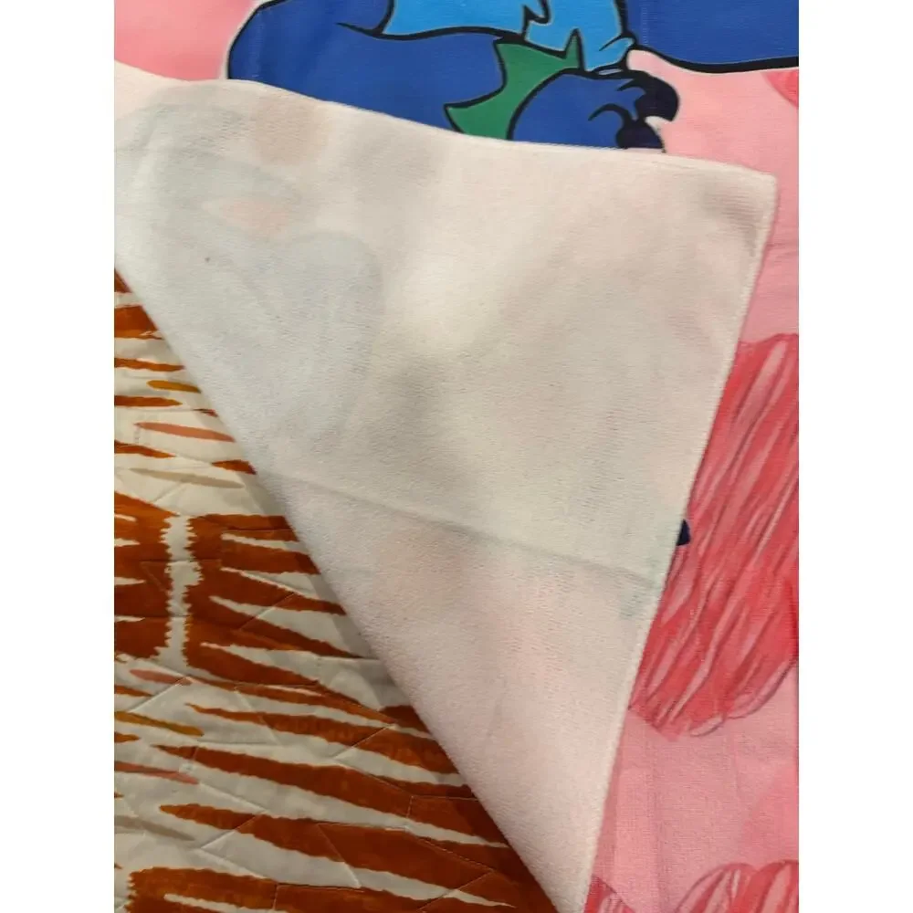 Stitch beach towel hula skirt and flower crown surrounded by hearts and cherries